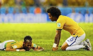 Brazil's Marcelo reacts next to teammate Neymar after Neymar was injured in a challenge against Colombia during their 2014 World Cup quarter-finals at the Castelao arena in Fortaleza